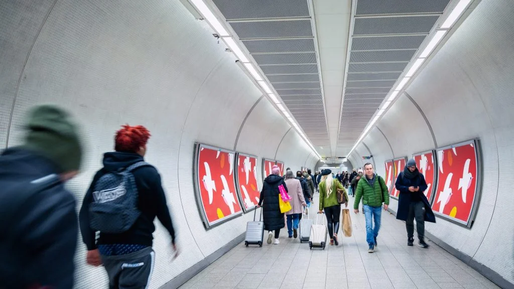 People walking through the an underground station on the Elizabeth Line.
