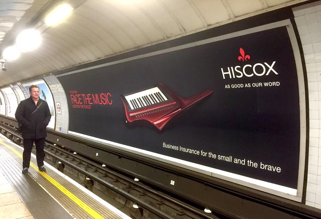 An advert for Hiscox appears across the track on the London Underground. This format is called a cross track paper 96-sheet.