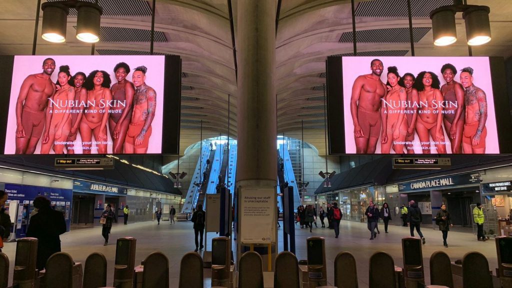 An advert for Nubian Skin on the London Underground using digital entrances.