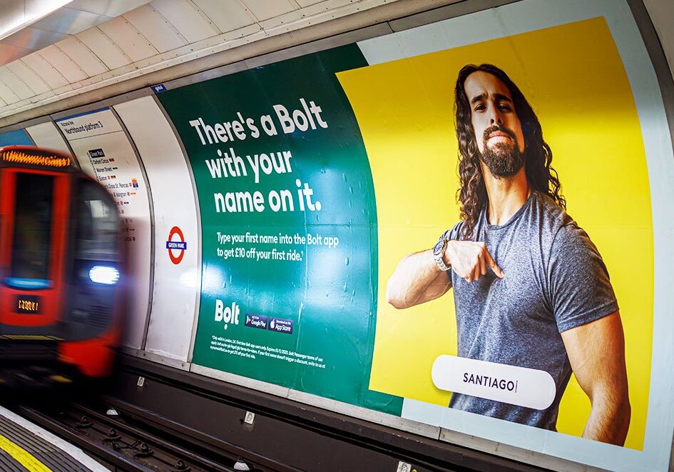 An advert for Bolt appears across the track on the London Underground.