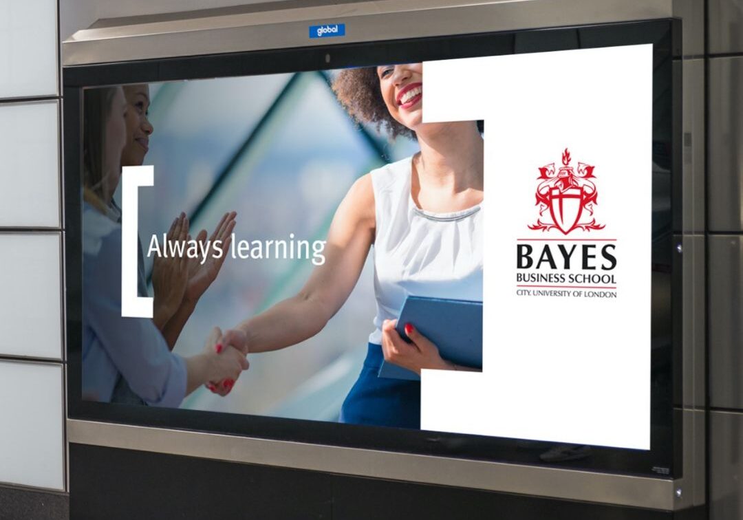 An advert displayed on the London Underground for Bayes Business School using a digital 12-sheet billboard.