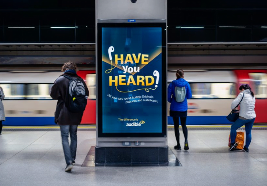 An advert for Audible displayed on the London Underground using a digital 6 sheet poster.